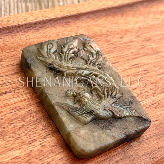 Flat carving labradorite peacock